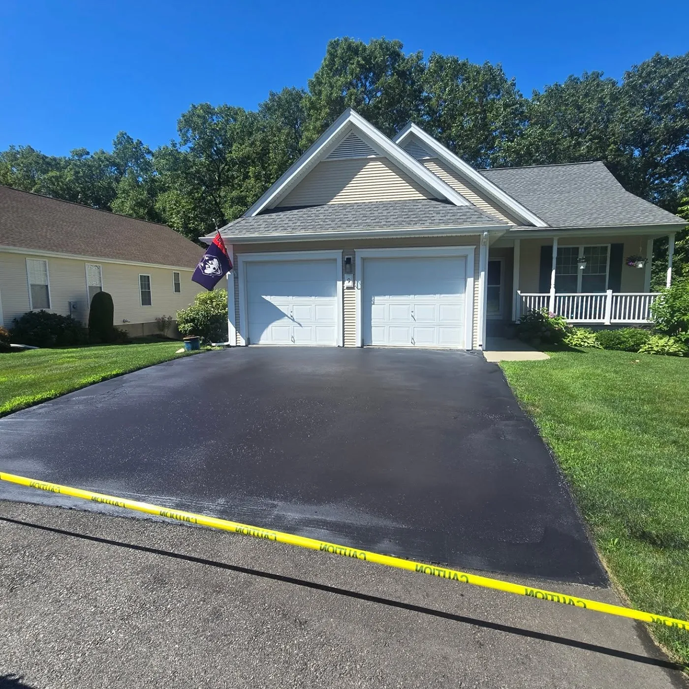 Freshly sealed black asphalt driveway