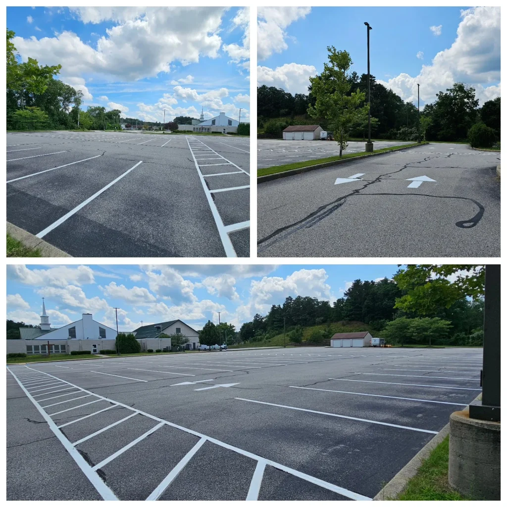 Newly striped asphalt parking lot with white lines, arrows, buildings, and trees.