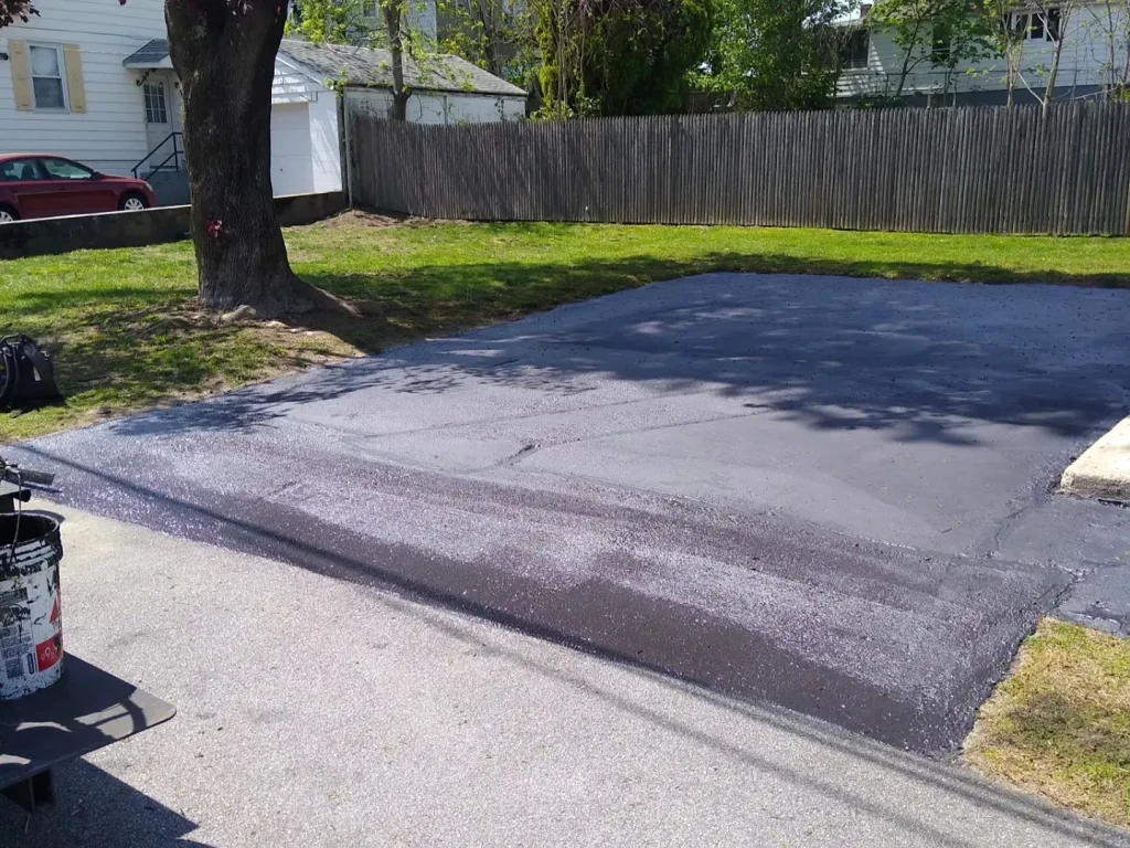 how long should i wait to sealcoat a brand new asphalt driveway in ri